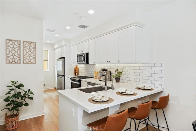 59 Sanctuary Ln, Mission Viejo, CA 92692 - kitchen featuring visible vents, light countertops, a sink, stainless steel appliances, and backsplash