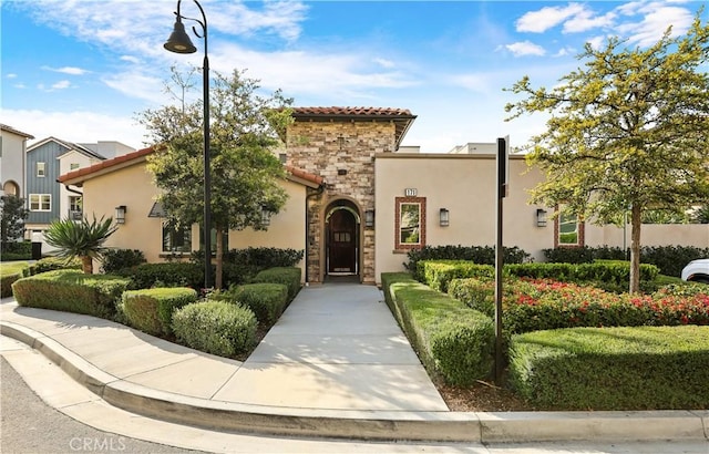 59 Sanctuary Ln, Mission Viejo, CA 92692 - view of front facade featuring stucco siding, stone siding, and a tile roof