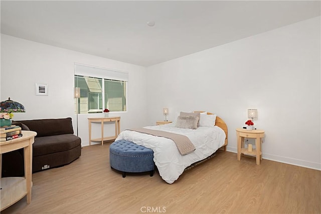 bedroom featuring wood finished floors and baseboards