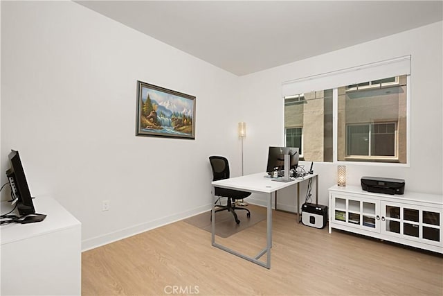 office featuring light wood-style flooring and baseboards
