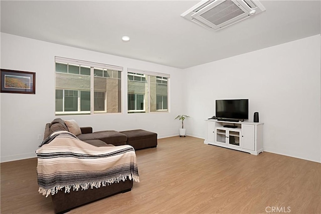living area featuring wood finished floors and baseboards