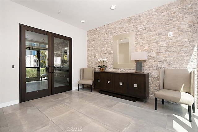 sitting room featuring french doors and baseboards