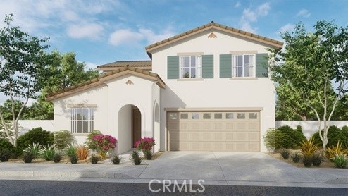 mediterranean / spanish-style home featuring concrete driveway, stucco siding, an attached garage, and a tile roof
