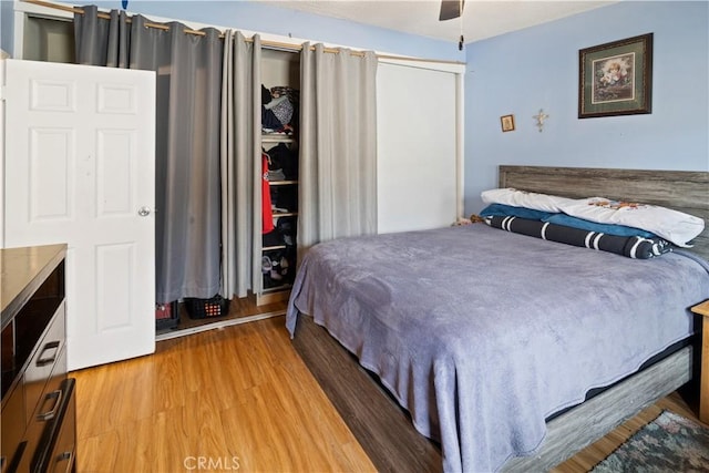 bedroom featuring ceiling fan and wood finished floors
