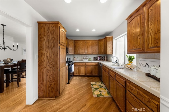 1492 Coolidge Ave, Pasadena, CA 91104 - kitchen featuring light wood-style flooring, brown cabinets, decorative backsplash, stainless steel appliances, and a sink