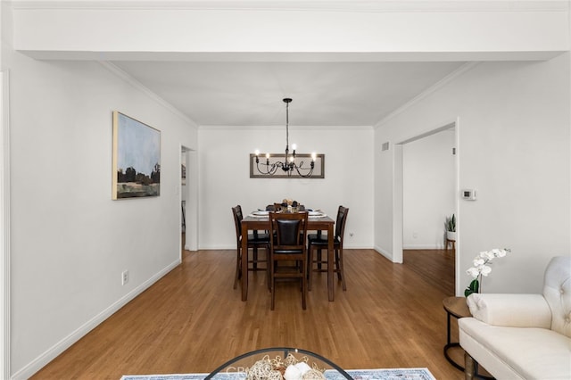 1492 Coolidge Ave, Pasadena, CA 91104 - dining room with wood finished floors, a notable chandelier, ornamental molding, and baseboards