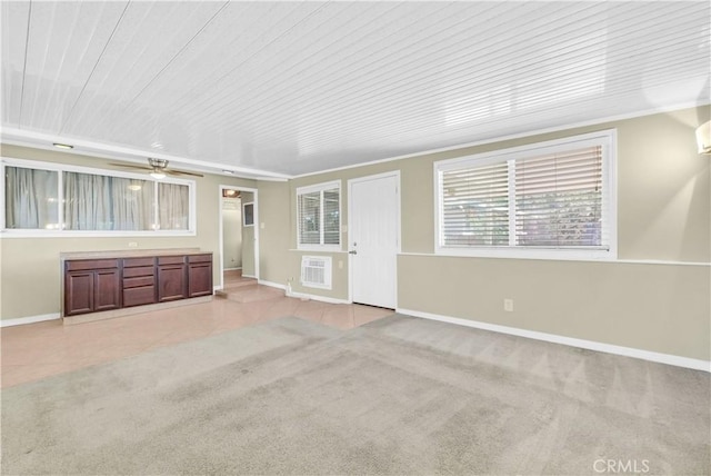 unfurnished living room with ceiling fan, light colored carpet, baseboards, wooden ceiling, and light tile patterned floors