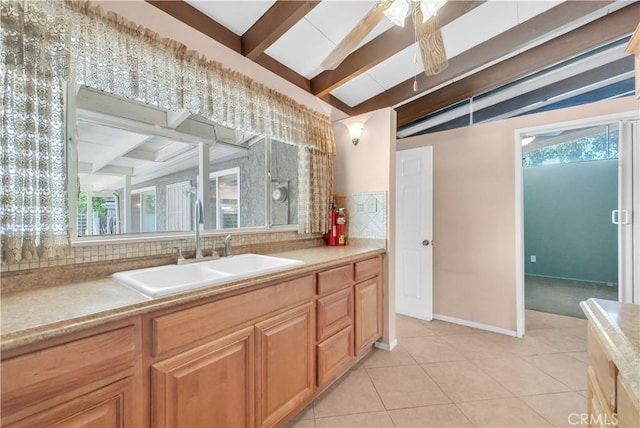 bathroom with tile patterned flooring, a ceiling fan, backsplash, and a healthy amount of sunlight