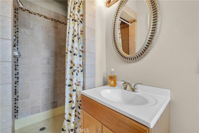 full bathroom with vanity and tiled shower