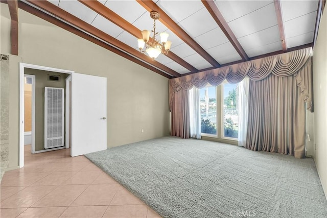 carpeted spare room with visible vents, tile patterned floors, lofted ceiling with beams, a chandelier, and a heating unit