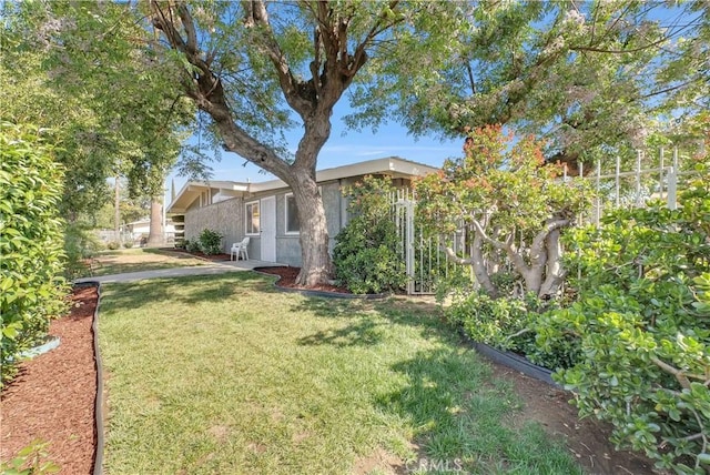 view of yard with fence and a garden