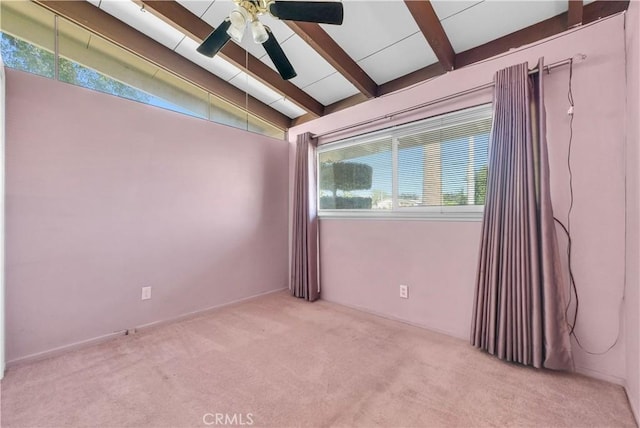 carpeted spare room featuring lofted ceiling with beams and ceiling fan