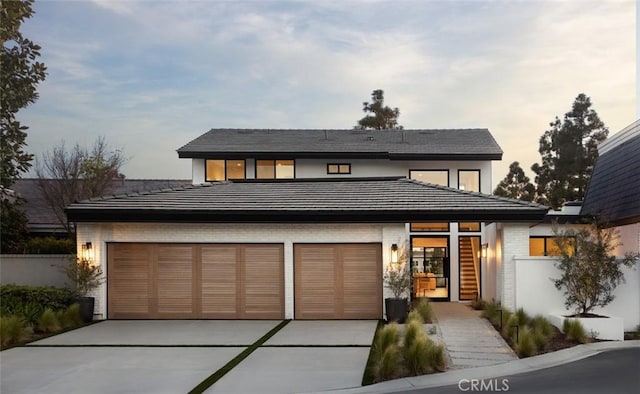 3 Rue Valbonne, Newport Beach, CA 92660 - prairie-style house featuring concrete driveway, brick siding, a garage, a tiled roof, and fence