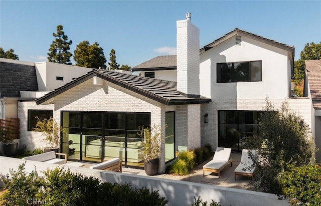 3 Rue Valbonne, Newport Beach, CA 92660 - back of house with brick siding and a chimney