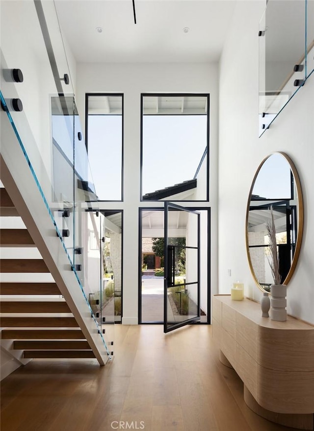 3 Rue Valbonne, Newport Beach, CA 92660 - staircase featuring recessed lighting, a high ceiling, and wood finished floors