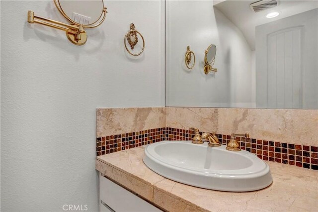 7200 Newton Way, Stanton, CA 90680 - bathroom with backsplash, vanity, and visible vents