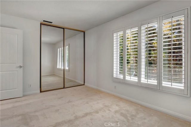 7200 Newton Way, Stanton, CA 90680 - unfurnished bedroom featuring carpet floors, baseboards, visible vents, and a closet