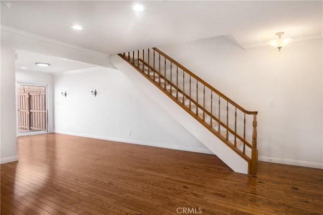 7200 Newton Way, Stanton, CA 90680 - unfurnished living room with recessed lighting, baseboards, crown molding, hardwood / wood-style flooring, and stairway
