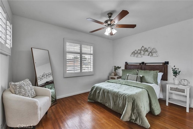 bedroom with wood finished floors, baseboards, and ceiling fan