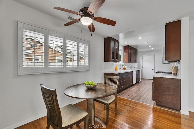 dining area with light wood-type flooring, baseboards, ceiling fan, and recessed lighting