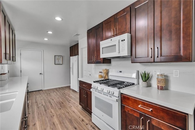 kitchen featuring recessed lighting, white appliances, visible vents, light wood-style floors, and light countertops