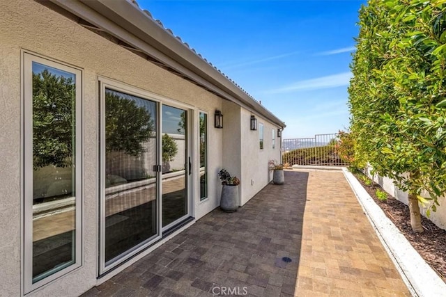 27553 Via Fortuna, San Juan Capistrano, CA 92675 - view of property exterior featuring fence, a patio area, and stucco siding