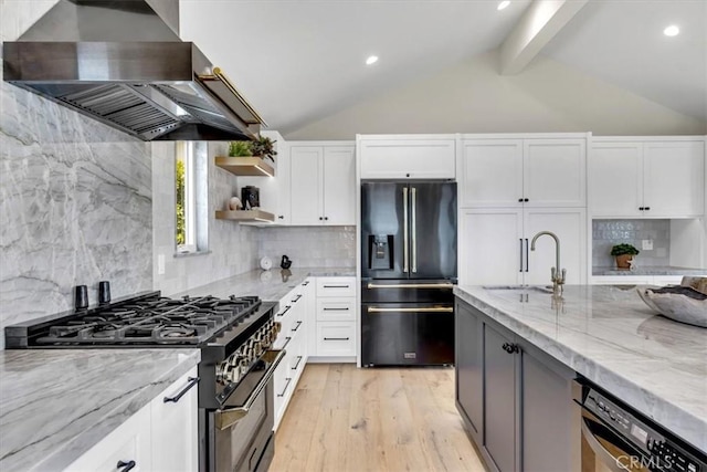 27553 Via Fortuna, San Juan Capistrano, CA 92675 - kitchen featuring a sink, black fridge with ice dispenser, wall chimney exhaust hood, light stone countertops, and gas stove