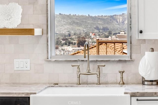 27553 Via Fortuna, San Juan Capistrano, CA 92675 - interior details featuring white cabinets, decorative backsplash, and a sink