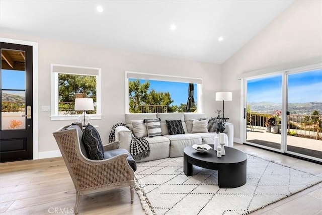 27553 Via Fortuna, San Juan Capistrano, CA 92675 - living room featuring recessed lighting, high vaulted ceiling, light wood-style flooring, and baseboards