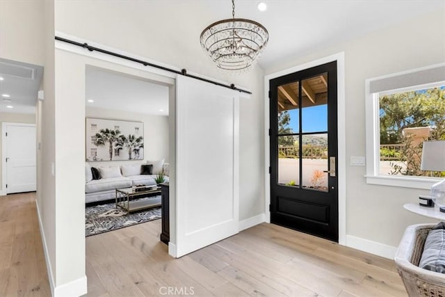 27553 Via Fortuna, San Juan Capistrano, CA 92675 - foyer featuring a barn door, a chandelier, light wood finished floors, baseboards, and recessed lighting