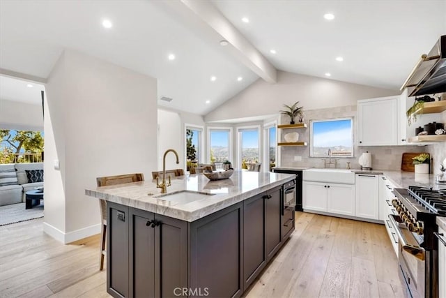 27553 Via Fortuna, San Juan Capistrano, CA 92675 - kitchen with open shelves, light stone counters, white cabinetry, and a sink