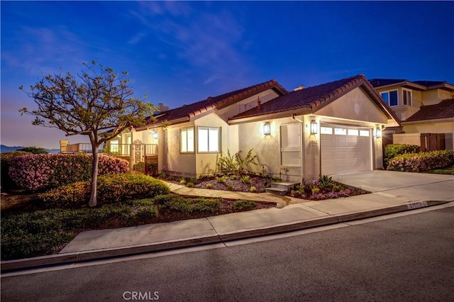 27553 Via Fortuna, San Juan Capistrano, CA 92675 - view of front of property featuring stucco siding, a tile roof, concrete driveway, and a garage