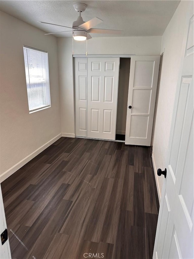 180 S 2nd Ave, Upland, CA 91786 - unfurnished bedroom with a closet, dark wood-type flooring, ceiling fan, and a textured ceiling