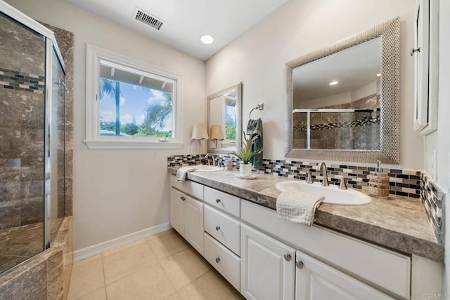 753 Jacquelene Ct, Encinitas, CA 92024 - bathroom featuring a shower stall, double vanity, tile patterned flooring, tasteful backsplash, and baseboards