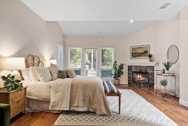 753 Jacquelene Ct, Encinitas, CA 92024 - bedroom with wood finished floors, baseboards, a fireplace, access to exterior, and vaulted ceiling