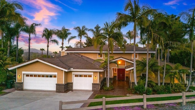 753 Jacquelene Ct, Encinitas, CA 92024 - view of front of property featuring driveway, fence, a tiled roof, brick siding, and an attached garage