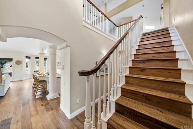 753 Jacquelene Ct, Encinitas, CA 92024 - stairs featuring arched walkways, ornate columns, hardwood / wood-style flooring, and baseboards