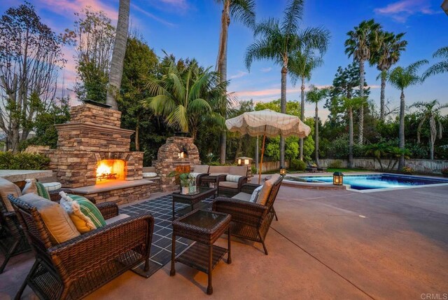 753 Jacquelene Ct, Encinitas, CA 92024 - patio terrace at dusk featuring an outdoor living space with a fireplace