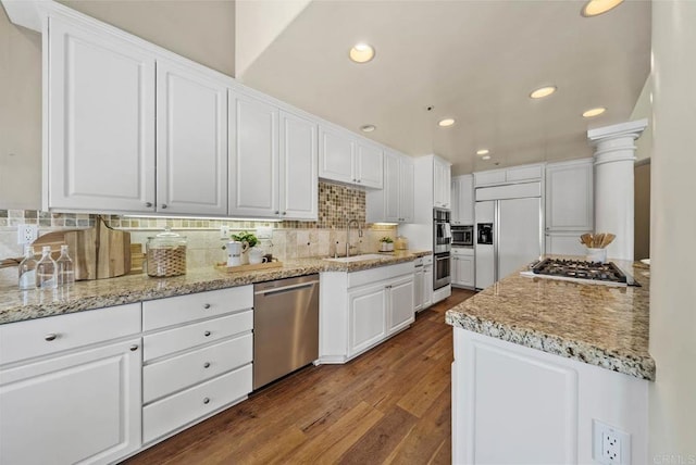 753 Jacquelene Ct, Encinitas, CA 92024 - kitchen featuring stainless steel appliances, a sink, dark wood finished floors, white cabinets, and tasteful backsplash