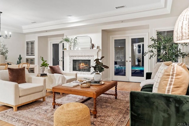 753 Jacquelene Ct, Encinitas, CA 92024 - living room with light wood-type flooring, french doors, a chandelier, crown molding, and a tray ceiling
