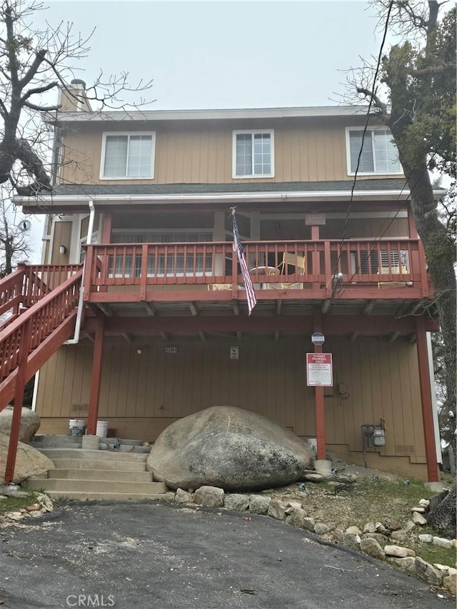 33361 Carlock Dr, Arrowbear, CA 92382 - rear view of house featuring a chimney