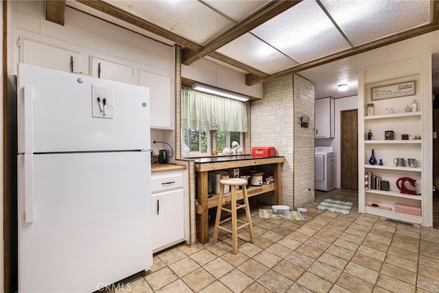 kitchen with freestanding refrigerator, visible vents, white cabinets, light countertops, and washer / dryer