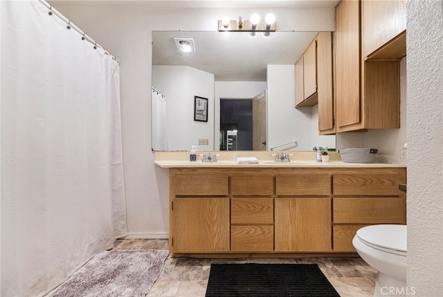 full bathroom with toilet and vanity
