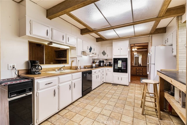 kitchen featuring white cabinets, under cabinet range hood, a sink, and black appliances