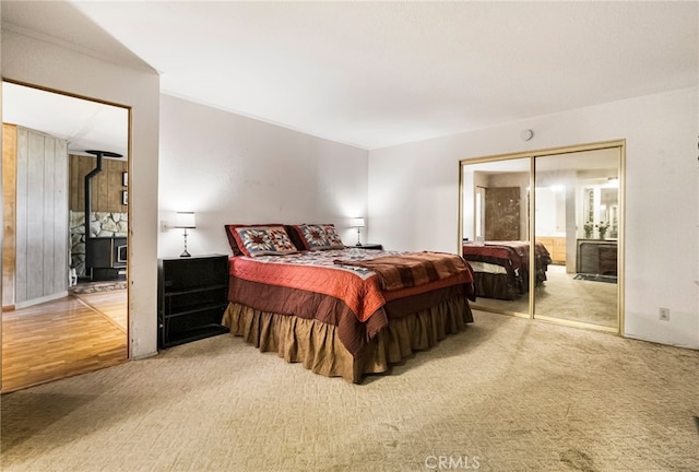 carpeted bedroom featuring a wood stove