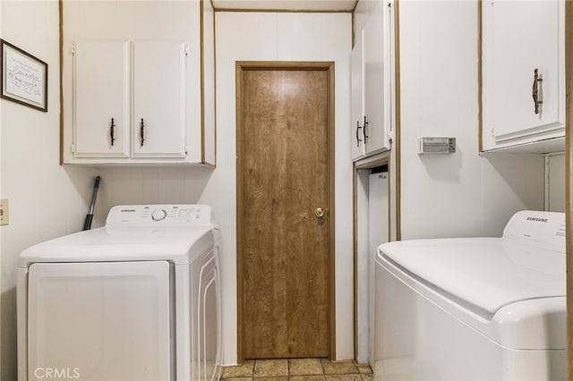 laundry area with washing machine and clothes dryer and cabinet space