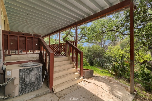 view of patio featuring central AC unit and stairway