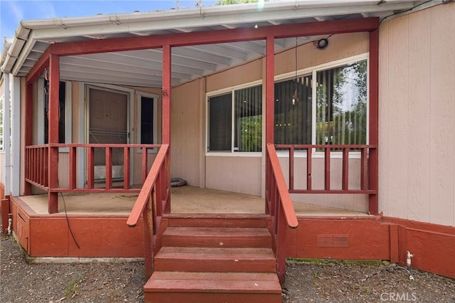 rear view of house featuring a porch