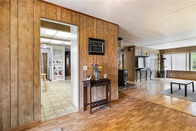 hall featuring wooden walls and wood finished floors