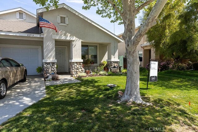 43564 Amazon St, Hemet, CA 92544 - view of front facade with an attached garage, stucco siding, a front lawn, concrete driveway, and stone siding
